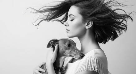 Young caucasian female embracing dog with flowing hair in black and white portrait