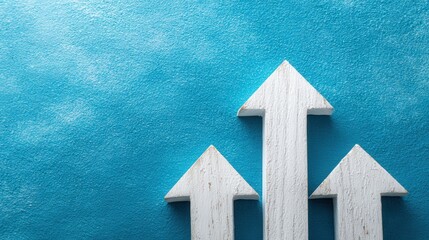 Three white wooden arrows pointing upwards are set against a textured bright blue background, creating a visually appealing and symbolic composition that represents growth, progress, and direction.