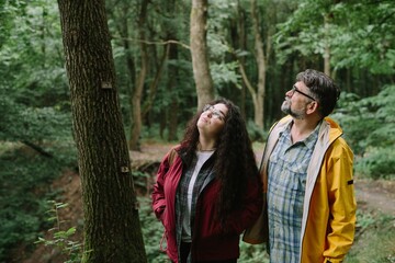 Father and daughter hiking exploring forest nature