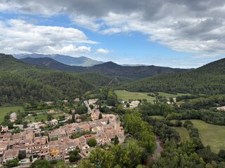 Beautiful small village on a valley rural scene on a cloudscape in Girona