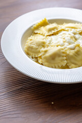 lose-Up of Italian Ravioli with Mozzarella and Olive Oil on a White Plate