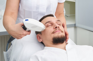 Fototapeta premium Man Having Laser Treatment At Beauty Clinic