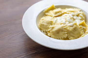 lose-Up of Italian Ravioli with Mozzarella and Olive Oil on a White Plate