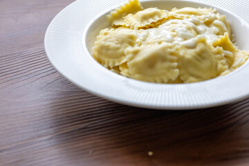 lose-Up of Italian Ravioli with Mozzarella and Olive Oil on a White Plate