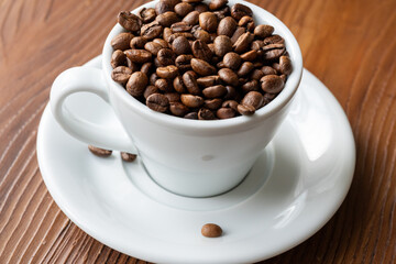 Coffee Beans in a Large White Cup on a Brown Table