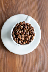 Coffee Beans in a Large White Cup on a Brown Table