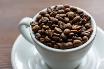 Coffee Beans in a Large White Cup on a Brown Table
