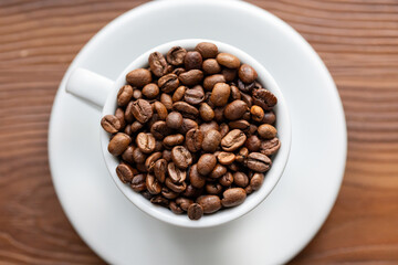 Coffee Beans in a Large White Cup on a Brown Table