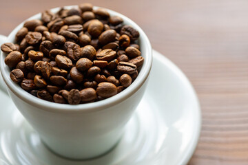 Coffee Beans in a Large White Cup on a Brown Table