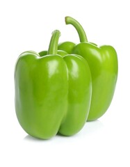 Two vibrant green bell peppers against white