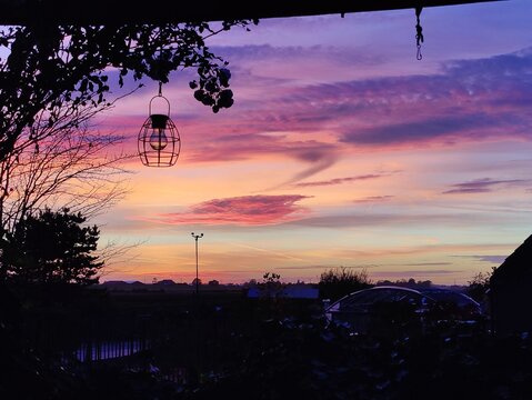 Vibrant Purple and Orange Sunset Over Serene Horizon