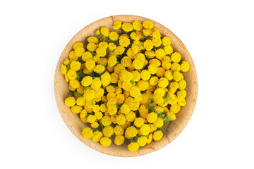 Tansy flower or Tanacetum vulgare in wooden bowl isolated on white background. Top view. Flat lay.
