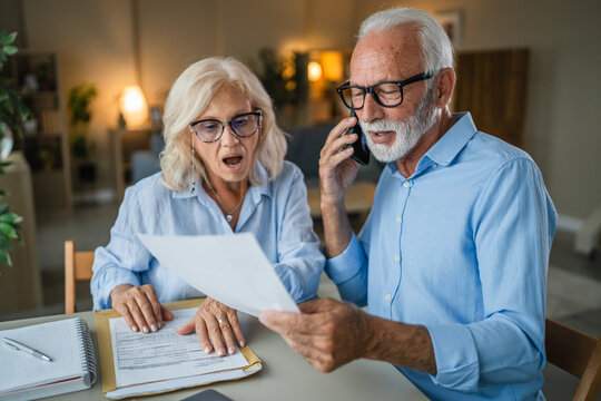 Senior couple discussing finances on a phone call