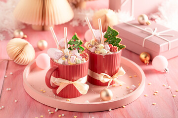 Delicious cocoa as dessert for Christmas eve in pink decoration.