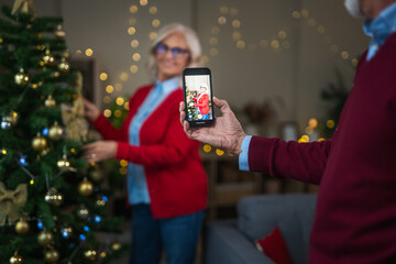 Senior couple making video call celebrating christmas holidays