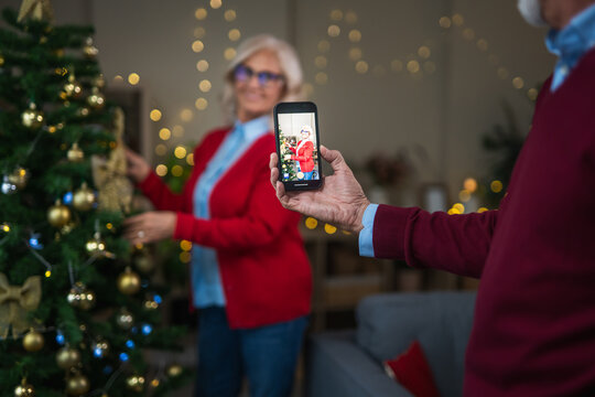 Senior couple making video call celebrating christmas holidays - Powered by Adobe