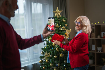 Senior woman celebrating christmas with family on video call