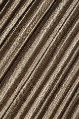 Gold fabric texture with diagonal pattern closeup background