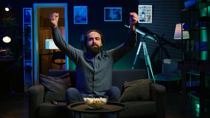 Fan watching live sports event on TV, chanting for team, having fun, doing choreography dance....