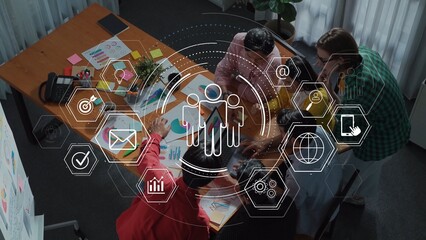 A diverse team collaborates in a modern office setting, analyzing data and utilizing technology to brainstorm, plan strategies, and drive project success. Raster