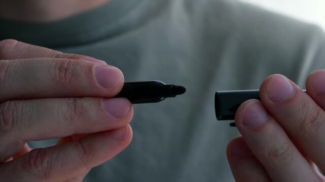 An office worker holding a black highlighter.
Highlighter, marker, writing, test, screenwriter