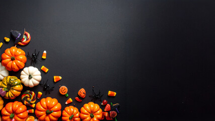 A Photorealistic Flat Lay of Halloween Sweets and Spooky Decor: Minimalist Style on a Midnight Black Canvas, background with space for text