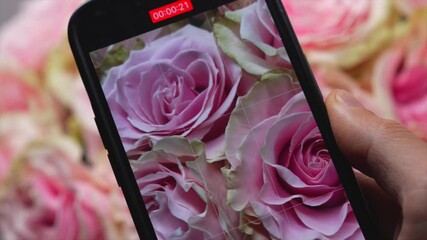 A content creator films a video in a flower shop with a smartphone camera.
Mobile videography and content creation.
A touchscreen camera captures the interior and flowers.