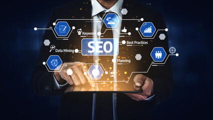 A businessman interacts with a tablet showcasing SEO concepts and data analysis elements, symbolizing modern digital marketing strategies and planning. Tessel
