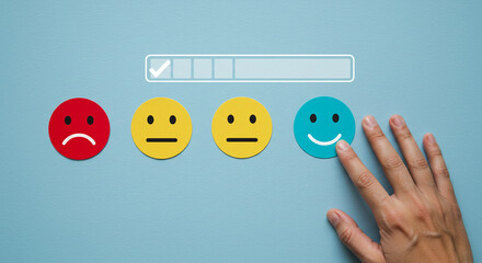 Confident hand choosing a delighted happy face emoji on a feedback scale, symbolizing outstanding customer satisfaction and positive service experience.