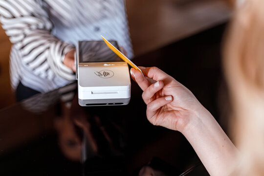 Payment transaction at a modern cafe using contactless method with a card