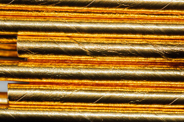 abstract close up of gold paper drinking straws