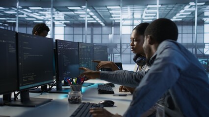 Engineer arrives in data center, puts headphones on, implementing AI systems. Server farm expert sitting down at desk, listening music and using artificial intelligence to prevent failures, camera A