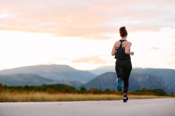 Determined Athlete Running in the Sun amidst Beautiful Nature