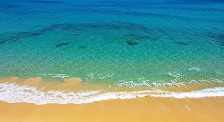 Aerial view of turquoise ocean meeting golden sandy beach during daylight