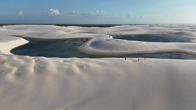 Golden sunset over the vast white sand dunes and crystal-clear lagoons of Lencois Maranhenses in Santo Amaro, Maranh&atilde;o, Brazil. A striking natural landscape of tropical beauty and shimmering water.