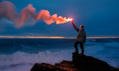 Dramatic Scene of a Person Signaling with a Flare Gun on a Rocky Coastline at Dusk, Against the Ocean's Waves