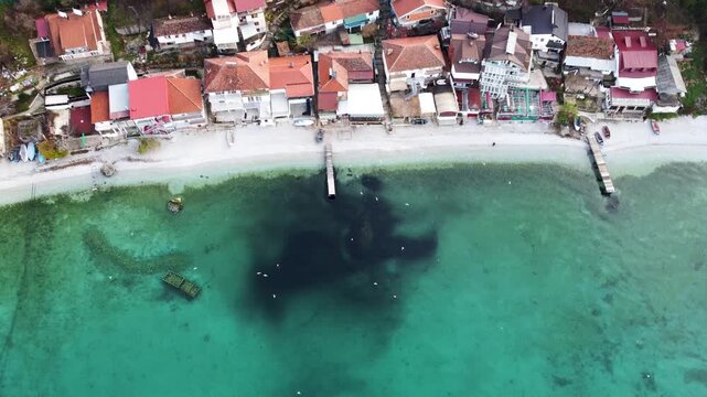 Aerial View of Trpejca Village on Lake Ohrid, Macedonia: Cloudy Day with Birds and Docks