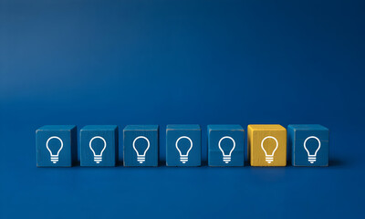 Wooden Blocks with Lightbulb Icons Concept Showing Unique Idea Stands Out in Team on Blue Background