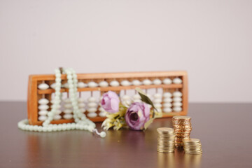 wooden abacus and pile of coins for islamic finance concept
