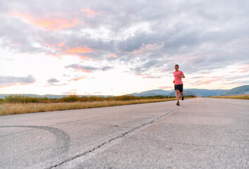 Obraz premium Determined Athlete Running in the Sun amidst Beautiful Nature