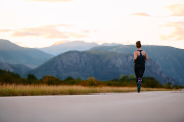 Fototapeta premium Determined Athlete Running in the Sun amidst Beautiful Nature