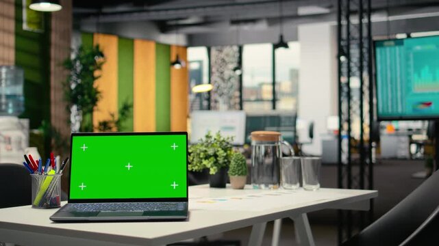 Green screen laptop in empty modern business workspace, human resources department office space prepared for hiring process, interviews and career development. Chroma key display on pc.