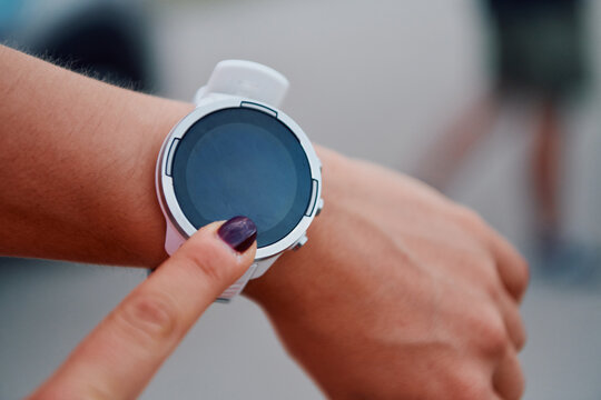 Close Up Woman Analyzing Workout Data on Smartwatch Post Run.