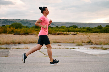 Determined Athlete Running in the Sun amidst Beautiful Nature