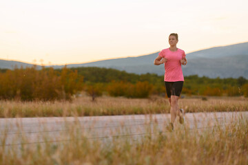 Determined Athlete Running in the Sun amidst Beautiful Nature