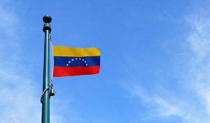High-quality venezuela national flag flag waving on a pole against a clear - Symbol of culture, heritage, and patriotism
