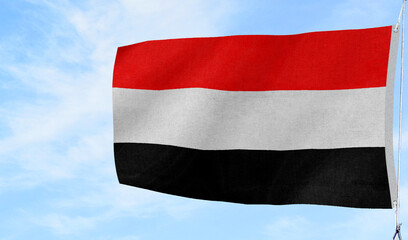 High-quality yemen national flag flag waving against a clear blue sky culture, - Symbol of culture, heritage, and patriotism