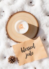Candle on wooden slice with handwritten note in snow background  
