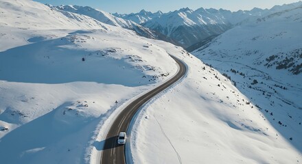 Aerial view of winding road through snowy mountain landscape
