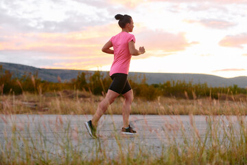 Determined Athlete Running in the Sun amidst Beautiful Nature